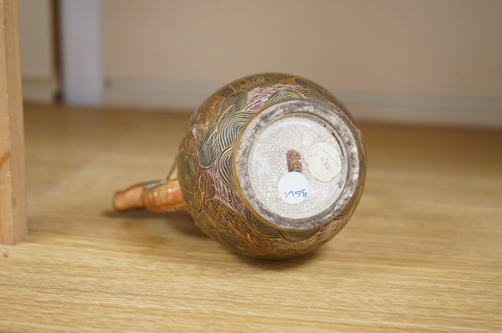 A Japanese Satsuma teapot and cover, signed, 17cm